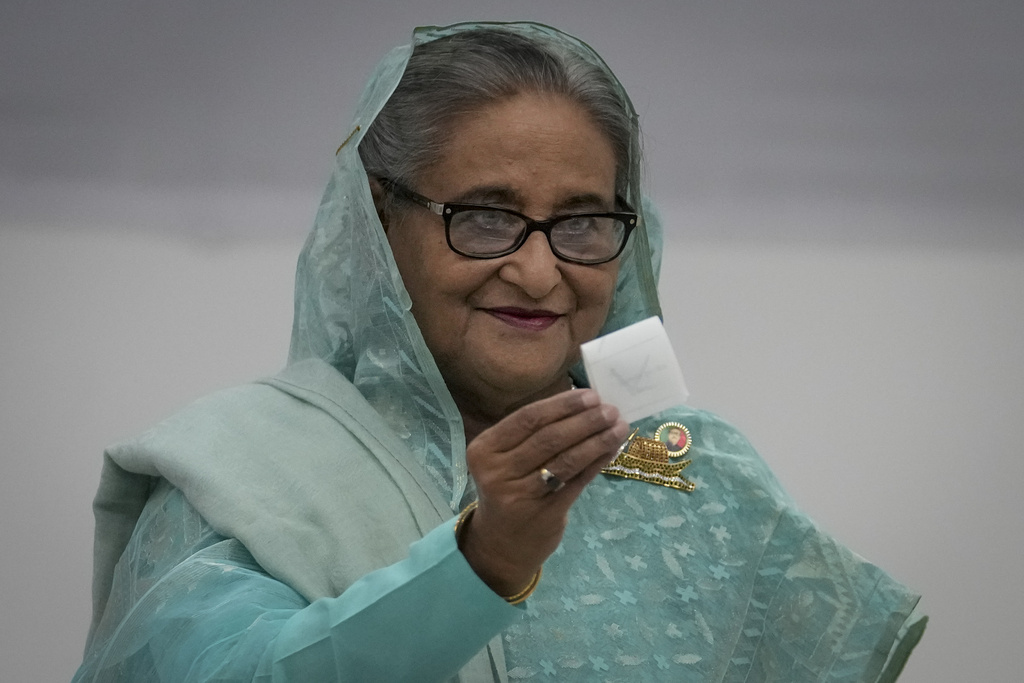 Bangladesh Prime Minister Sheikh Hasina shows her ballot paper as she casts her vote in Dhaka, Bangladesh, Sunday, Jan. 7, 2024.