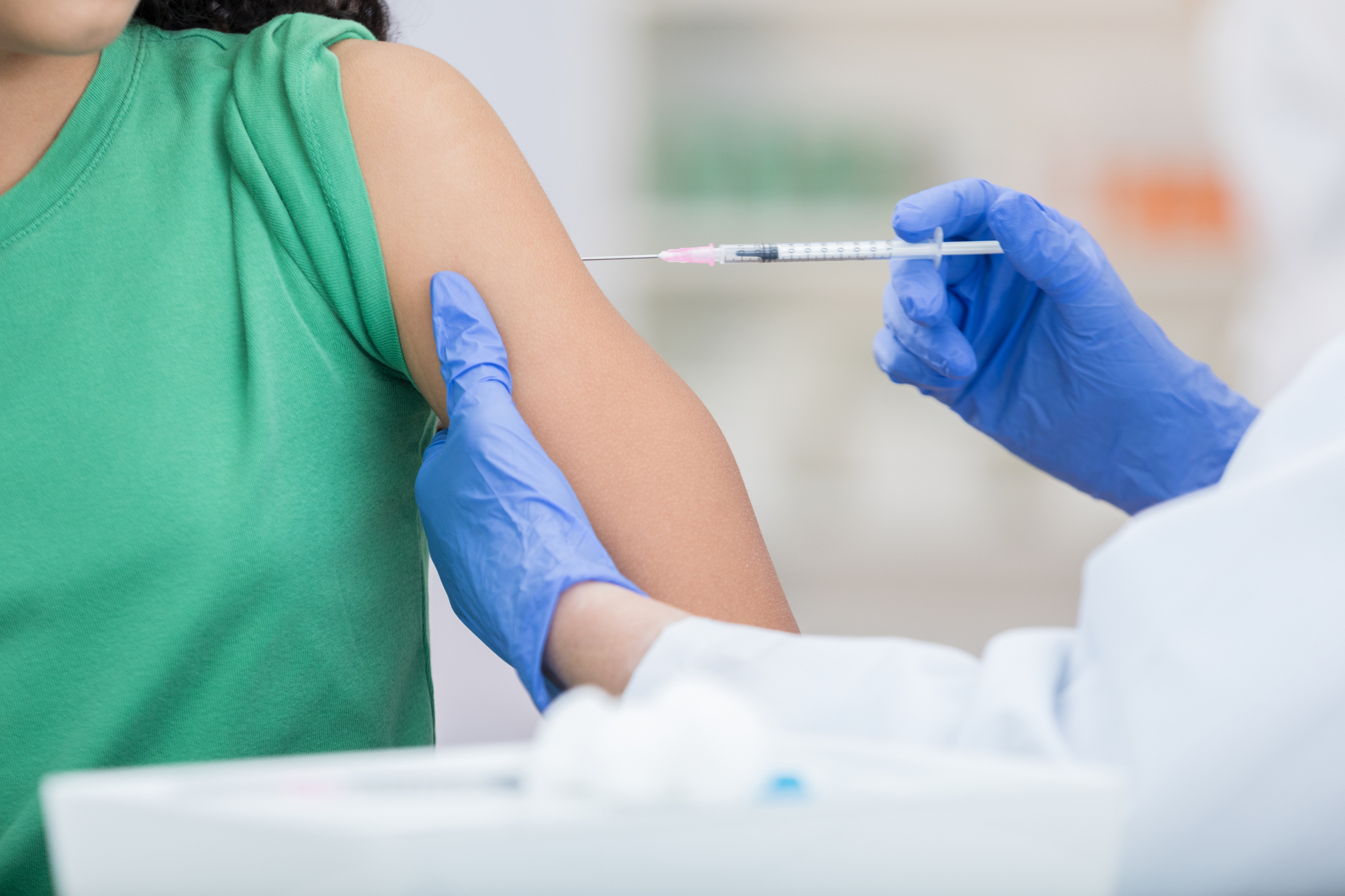 Unrecognizable girl receives flu shot