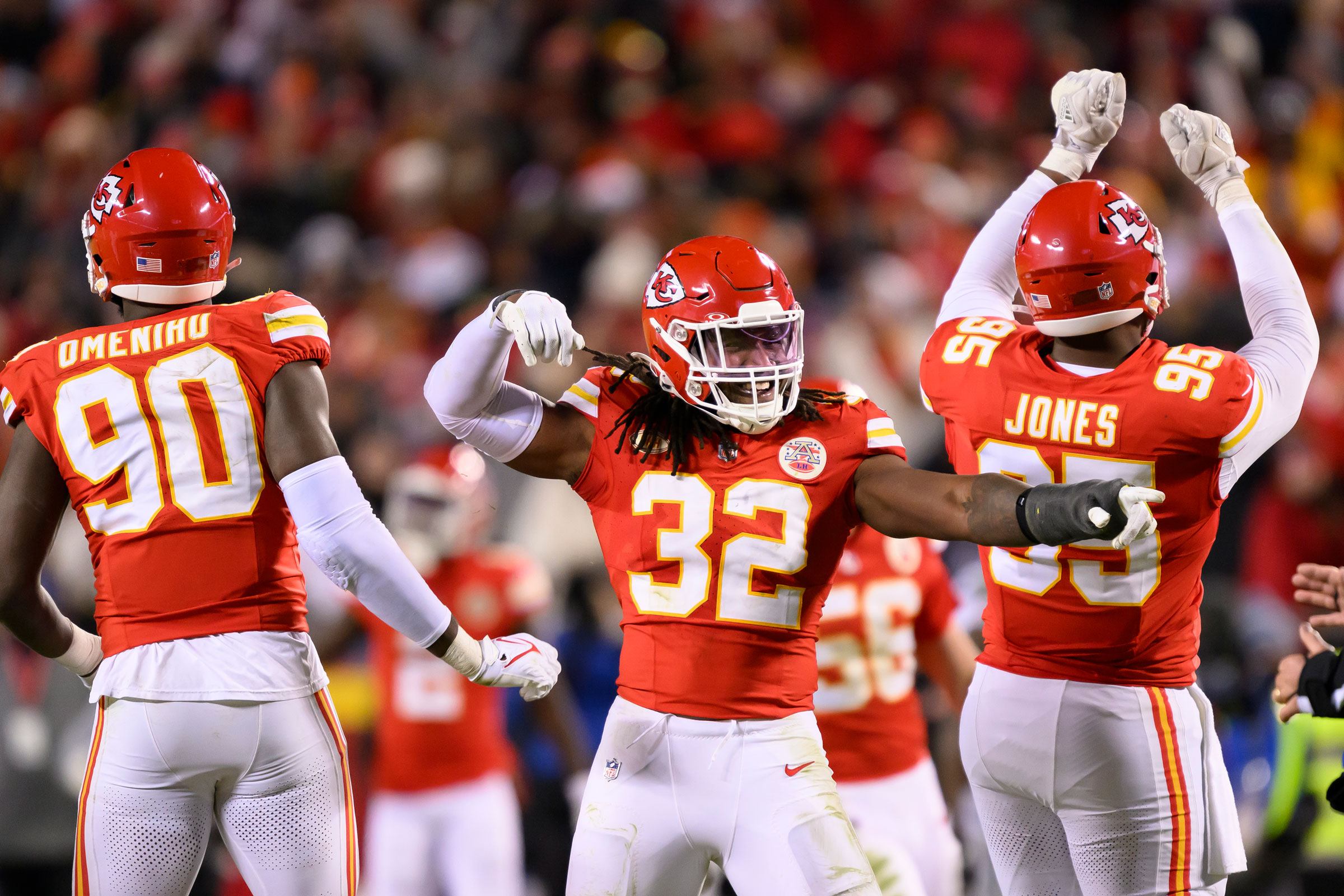 Kansas City Chiefs defensive players Charles Omenihu, Nick Bolton, and Chris Jones celebrate a sack