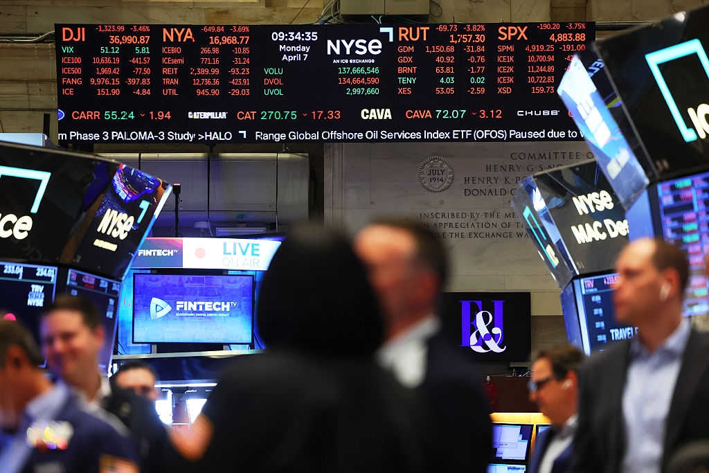 Stock market numbers are displayed as traders work on the floor of the New York Stock Exchange during morning trading on April 07, 2025 in New York City.