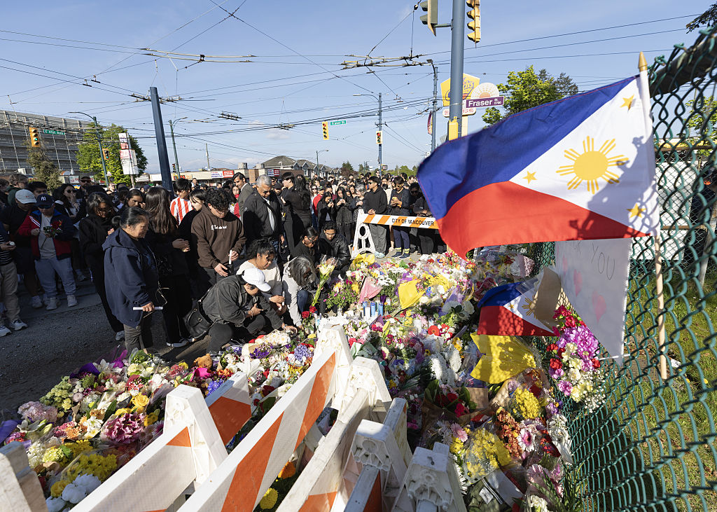 People attend a candlelight vigil near the scene where a car drove into a crowd at the Lapu-Lapu Festival on April 27, 2025 in Vancouver, Canada.