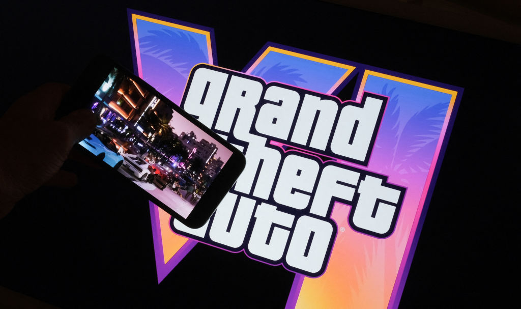 Rockstar Games' Grand Theft Auto VI trailer plays on a screen in front of the game title 