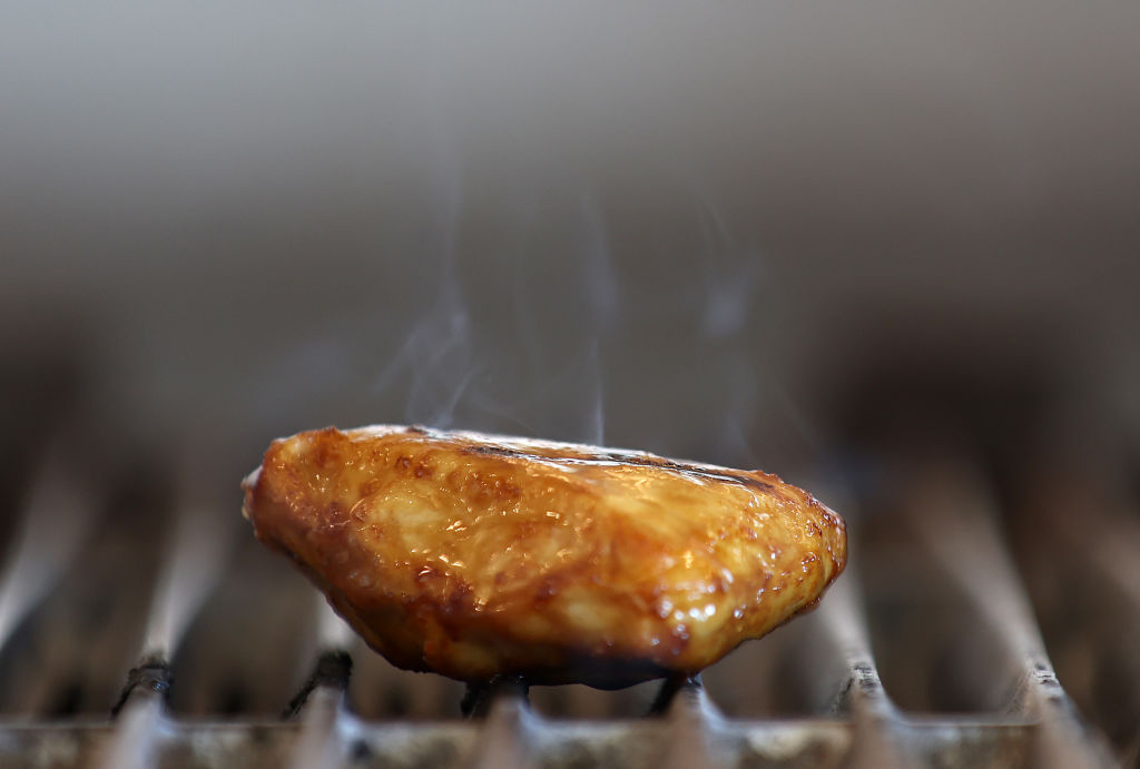 A piece of Good Meat's cultivated chicken cooks on a grill at the Eat Just office on July 27, 2023 in Alameda, California. 