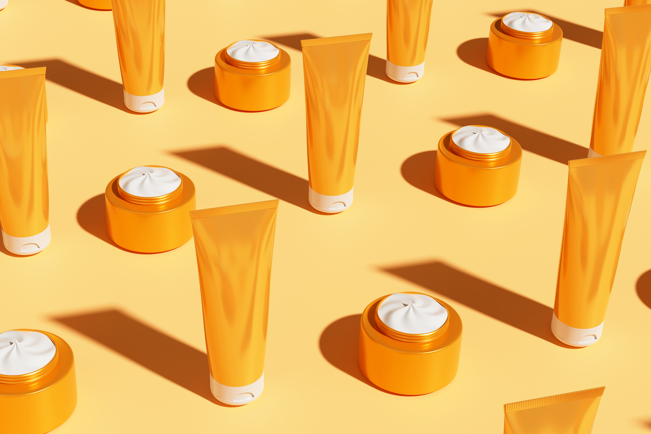 Sunscreen containers on a yellow background. 