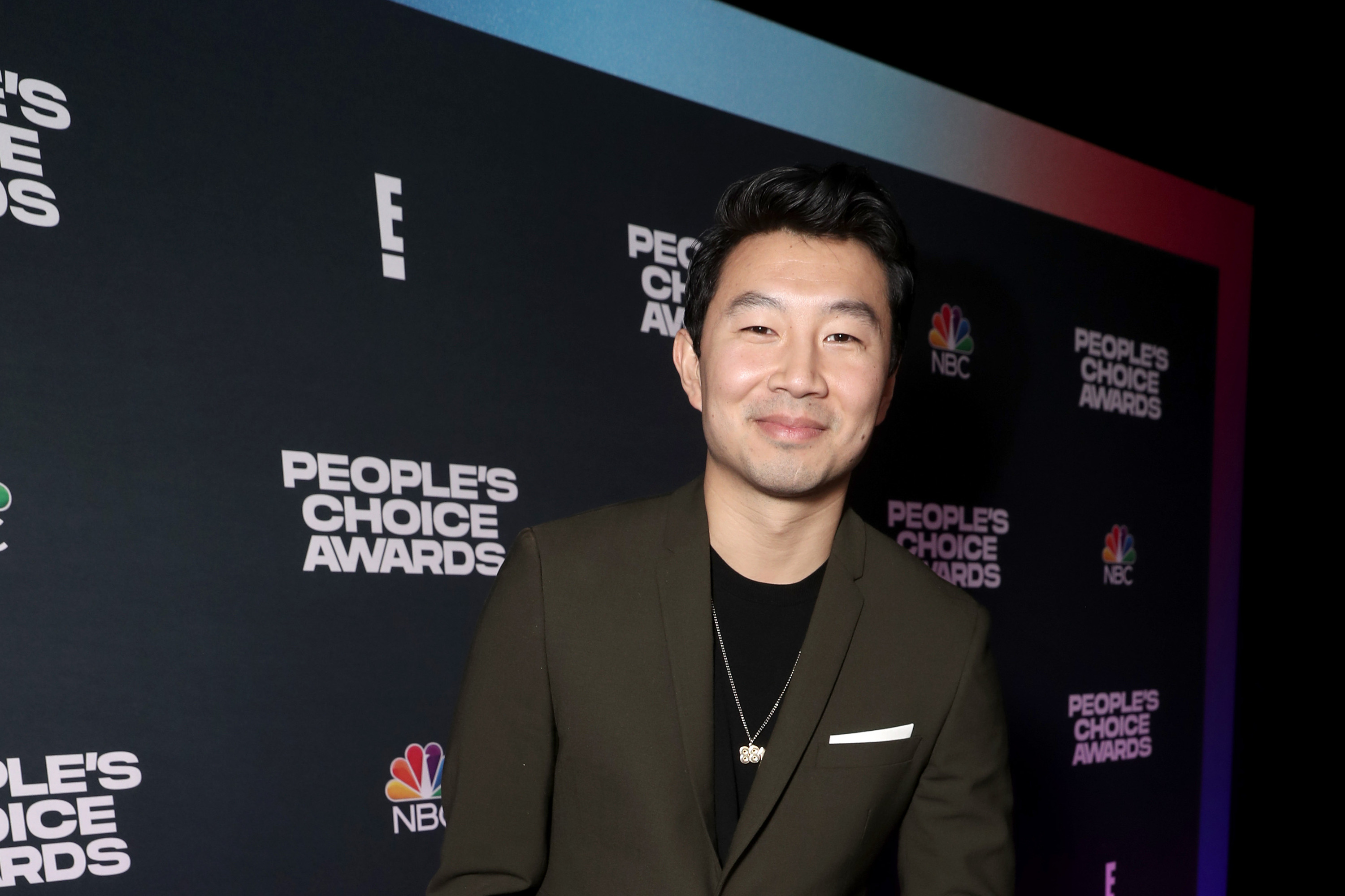 SANTA MONICA, CALIFORNIA - DECEMBER 07: 2021 PEOPLE'S CHOICE AWARDS -- Pictured: Simu Liu, recipient of The Action Movie Star of 2021 for 'Shang-Chi and the Legend of the Ten Rings,' poses backstage during the 2021 People's Choice Awards held at Barker Hangar on December 7, 2021 in Santa Monica, California. (Photo by Todd Williamson/E! Entertainment/NBCUniversal/NBCU Photo Bank via Getty Images)