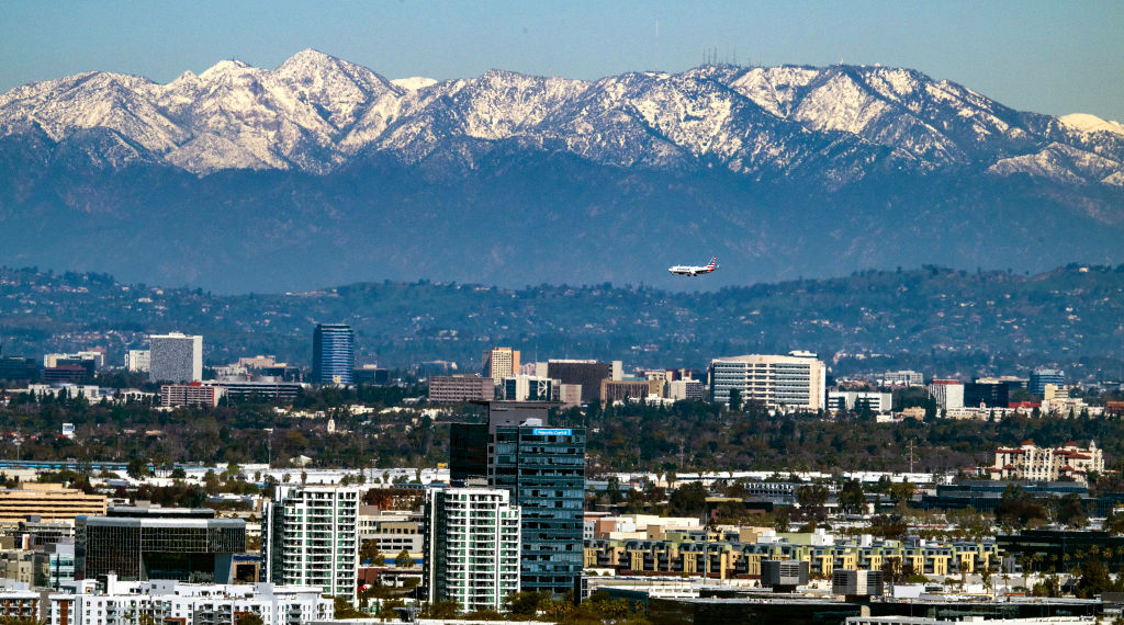 A break in winter storms reveals snow-covered mountains across Southern California following heavy rain, snow and wind