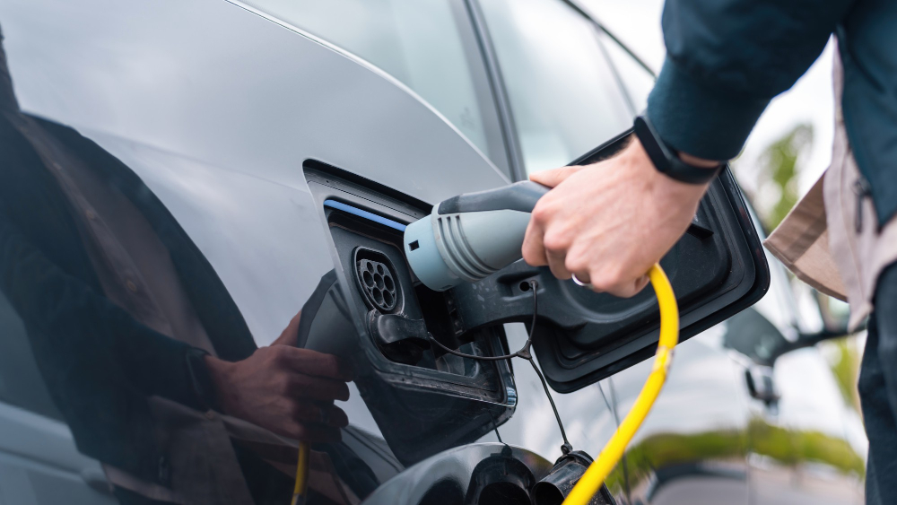 man plugging charger into electric car charge station 4 LIFT Announces Changes to its Board of Directors