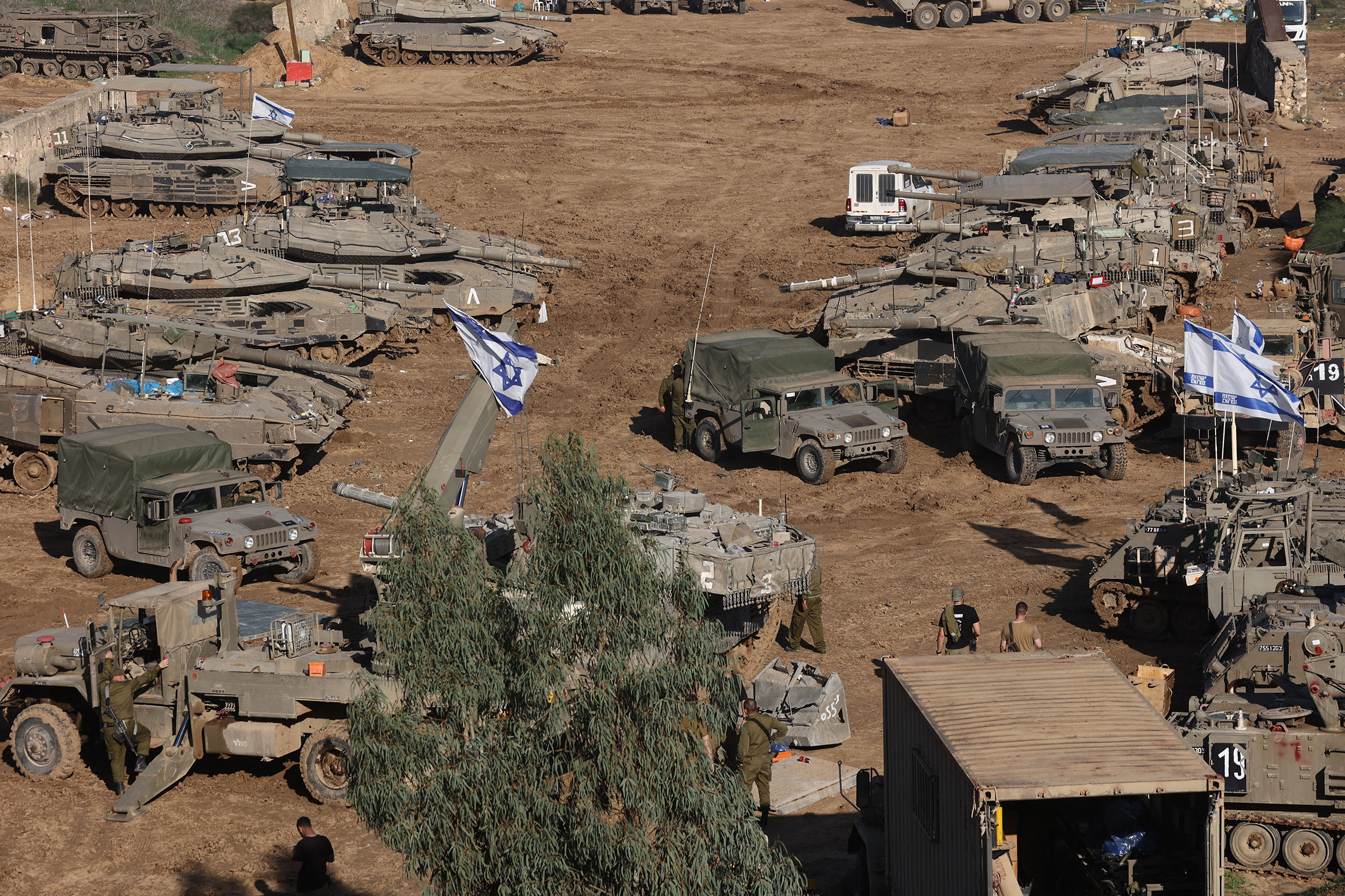 Israeli armored vehicles and troops are deployed in southern Israel, near the border with the Gaza Strip on Dec. 15, 2023.