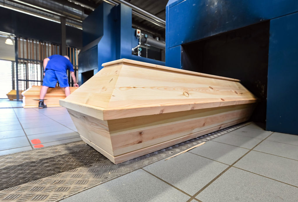 Coffins stand in front of cremation ovens at the crematorium in Karlsruhe's main cemetery in Baden-Württemberg, Germany on July 14, 2022.