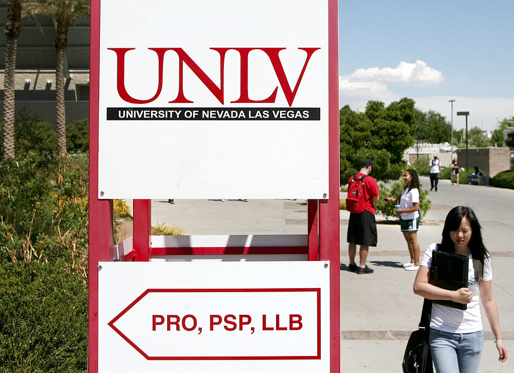 A student walks past a sign outside Lied Library on the Univ