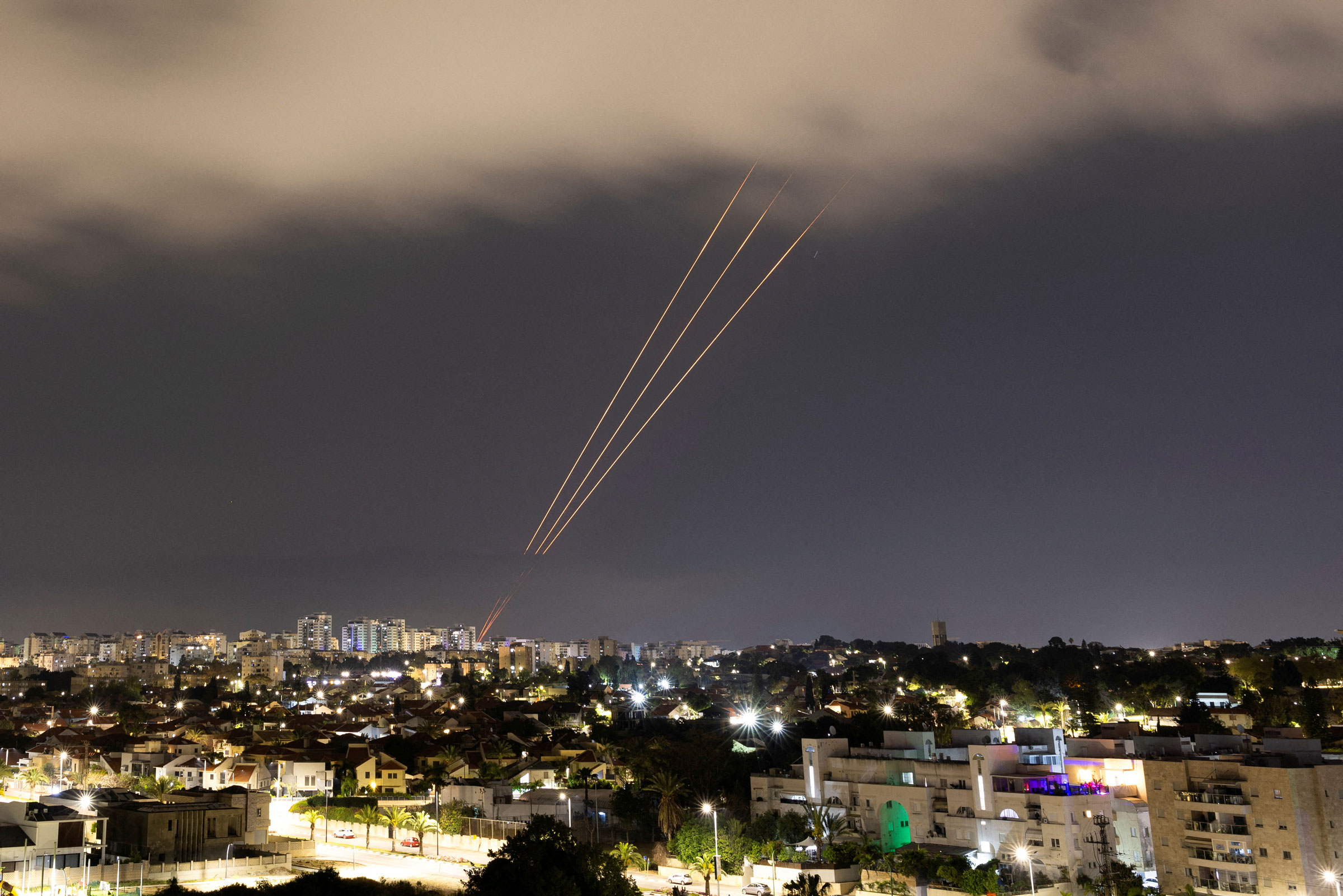 An anti-missile system operates after Iran launched drones and missiles towards Israel