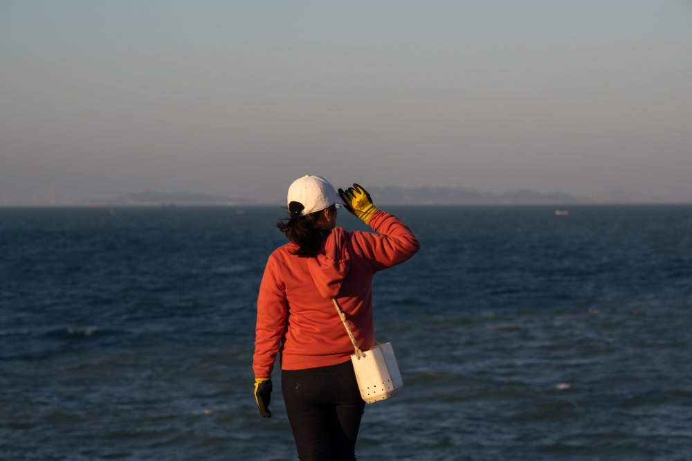 Lin Yu-mei, who returned to Wuqiu to vote and visit her mother, looks off at mainland China just miles away. Jan 13, 2024.