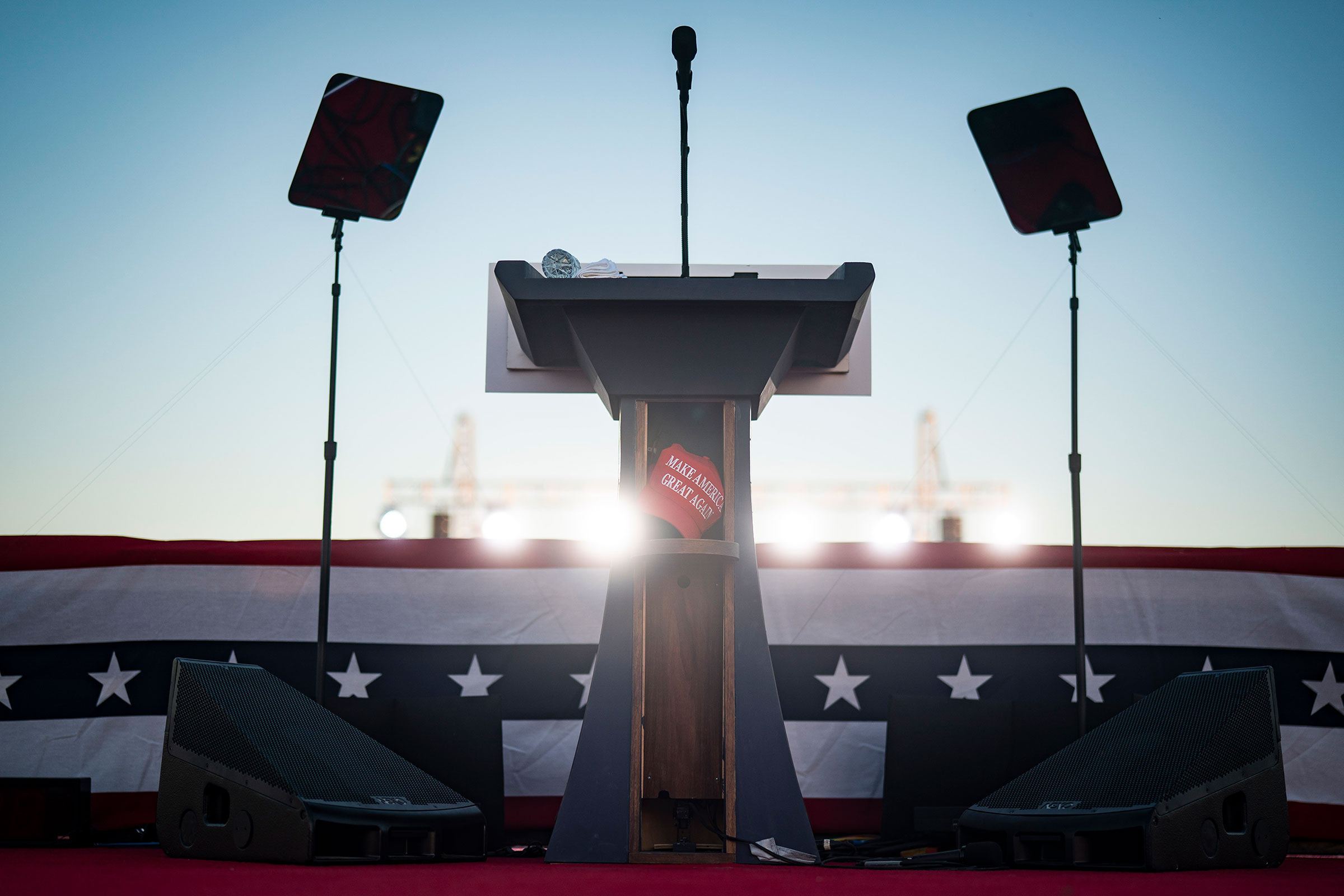 A Make America Great Again hat is seen left behind on the podium by former President Donald Trump after he spoke at a campaign rally at the Waco Regional Airport on March 25, 2023.