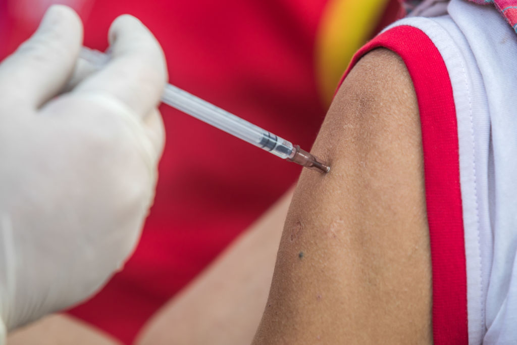 A health worker administers a dose of Janssen COVID-19 vaccine to a homeless person during a vaccination campaign for transgender community and homeless people  in Central Shaheed Minar, Dhaka, Bangladesh.