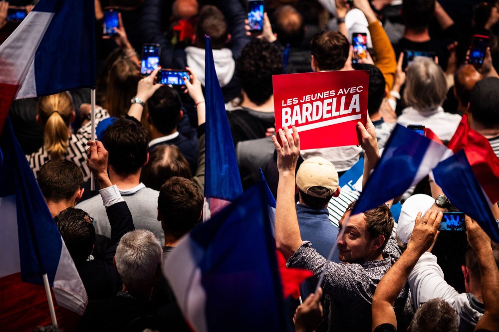 French far-right National Rally party leader Marine Le Pen, centre and president Jordan Bardella salute supporters at a meeting in Marseille, southern France, on March 3, 2024.