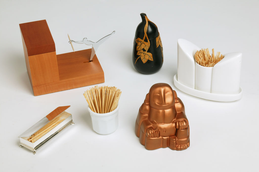 Toothpick holders, clockwise form top left, pear wood toothpick stand from Alessi, carved stone eggplant toothpick holder from Asian Artworks, Maxwell and Williams toothpick holder with salt and pepper shakers from Indigo, brass Buddha toothpick holder wi