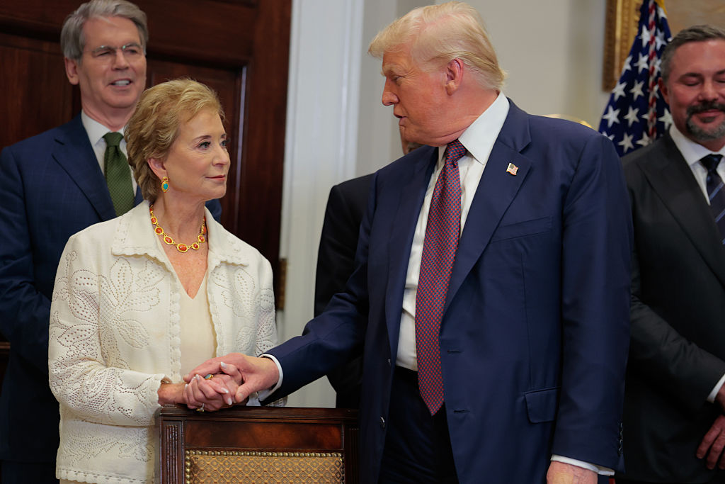 President Donald Trump speaks with Secretary of Education Linda McMahon