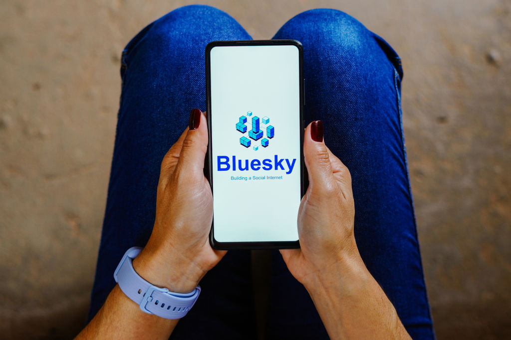 In this photo illustration, the Bluesky logo is displayed on