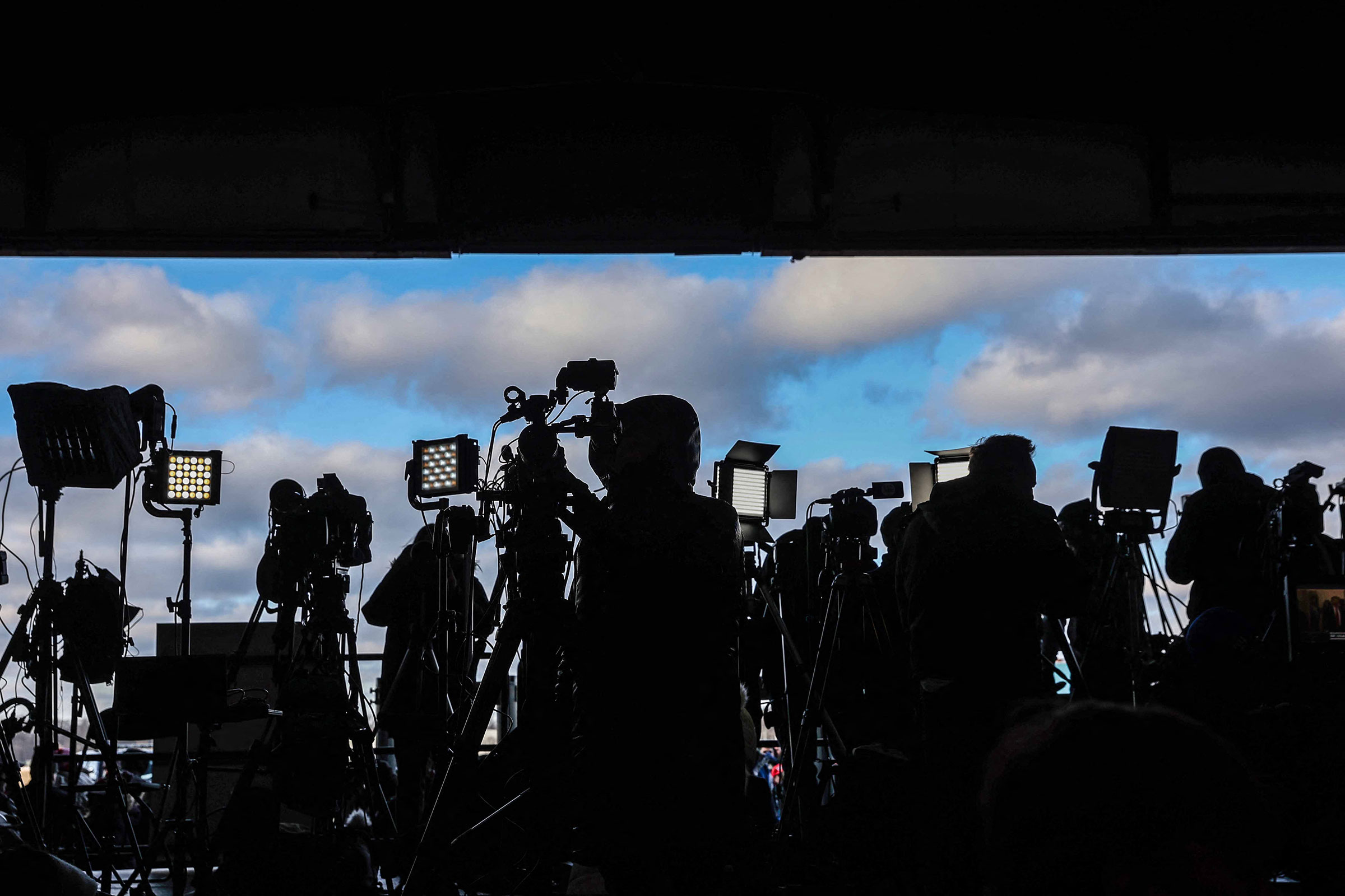 Members of the media wait for the arrival of former President Donald Trump at a 