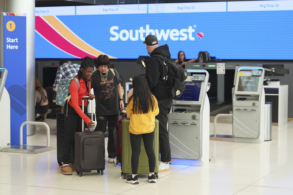 Passengers check in at a kiosk at the ticketing counter for Southwest Airlines in Denver International Airport Thursday, Feb. 27, 2025. 