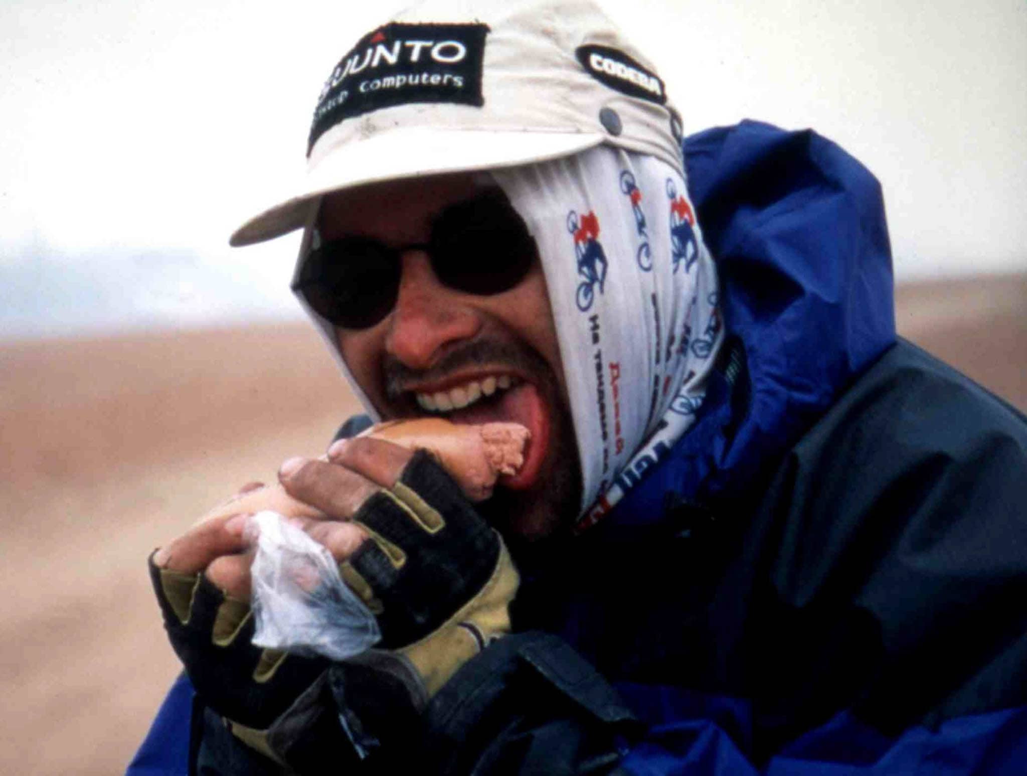 Cyclist on an adventure. Wearing a Original Buff® as balaclava. Eating something. (buff.eu)