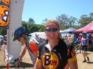 Scott smiling into the camera at the 2005 24 hour mtb race in Kooralbyne. It is hot. He is wearing a Original Buff® as helmet liner to cool down. It also stops sweat from running into his eyes. © Buff Downunder Pty Ltd