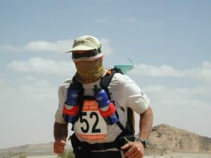 A participant of the Marathon Des Sables running through the desert. He is wearing a custom made High Uv Buff® as face mask. Copyright is unknown. Distributed by Original Buff® S.A. for the promotion of Buff® products