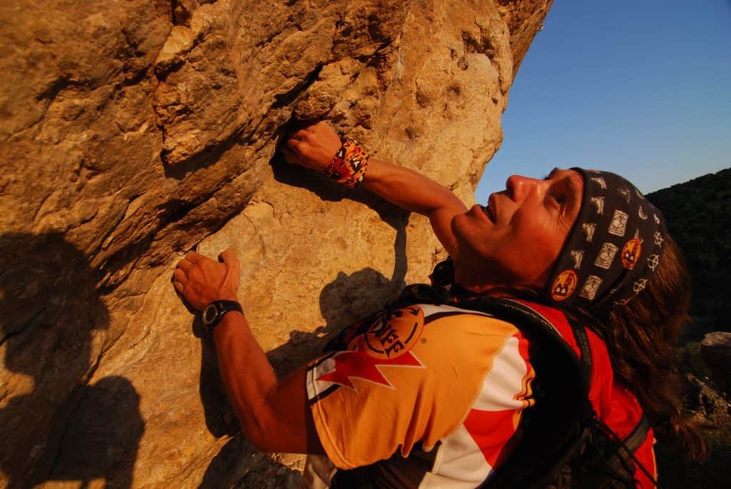 A member of the Buff® Adventure Racing Team climbing up a cliff. He is wearing a Original Buff® as sweatband. © Original Buff S.A. Released for the promotion of Buff® products