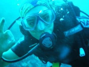 Frontal landscape shot of a female diver wearing a Arocsport Original Buff® as hair cover. The photo is taken underwater. The diver signals that she's fine. Source: Arocsport.com.au © Permission to use on our websitesFrontal landscape shot of a female diver wearing a Arocsport Original Buff® as hair cover. The photo is taken underwater. The diver signals that she's fine. Source: Arocsport.com.au © Permission to use on our websites