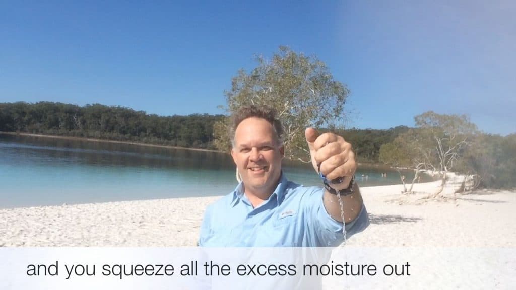 Edward squeezing the water out of the wet Original Buff®. You can clearly see the water flowing out.