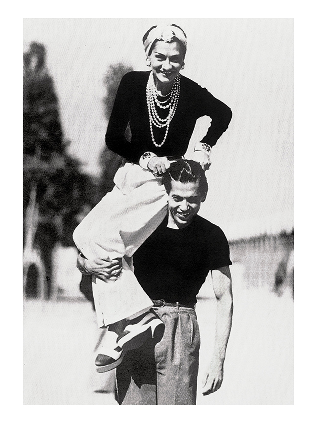 Gabrielle Chanel on the shoulders of her friend, Serge Lifar, in 1937