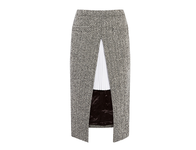 Borrowing once again from the vocabulary of menswear, this herringbone pencil skirt is anything but ordinary. The split front is contrasted against a crisp pleated twill underlay: all the better to have fun in.