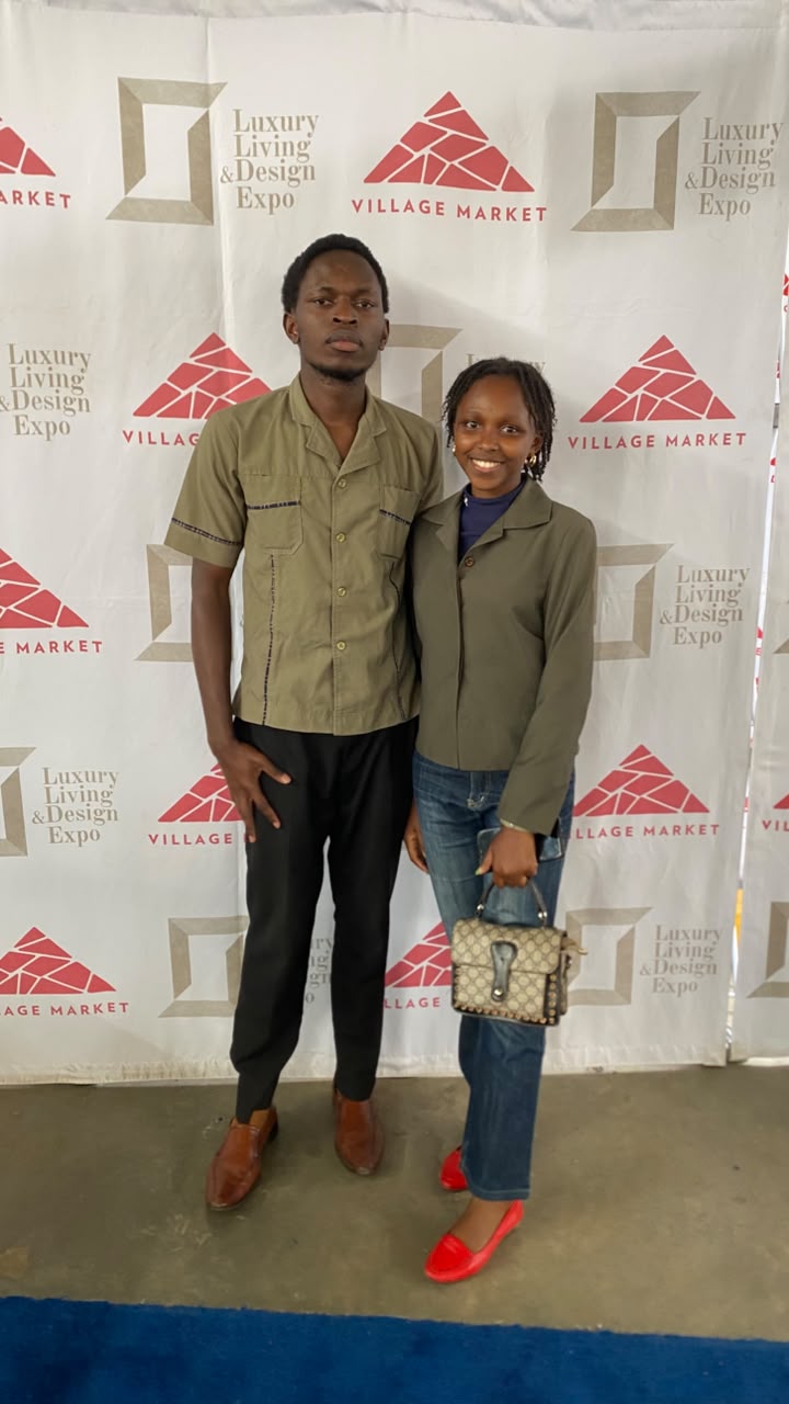 The author posing with a fellow NOMP mentee at the Village Market backdrop during the Luxury Living and Design Expo