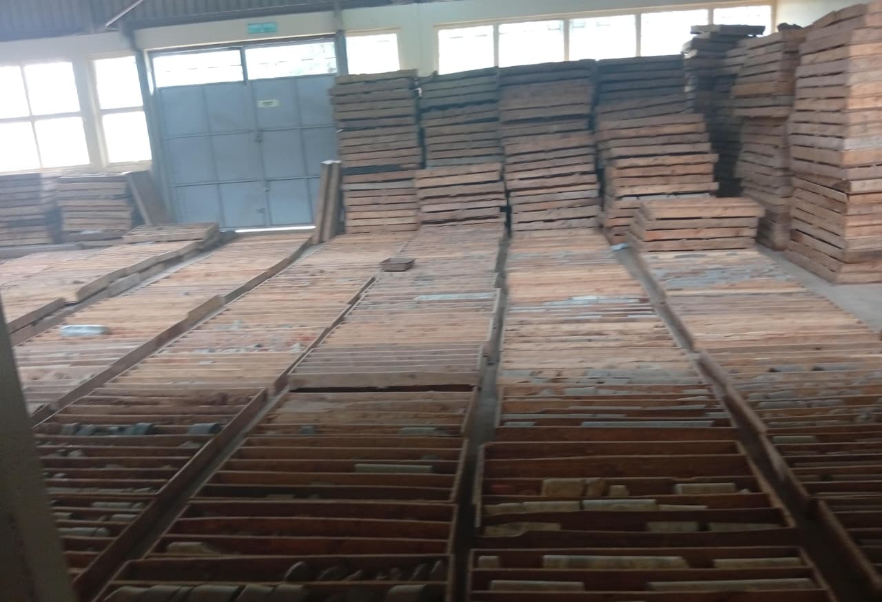 Stacks of timber formwork boards stored in a warehouse
