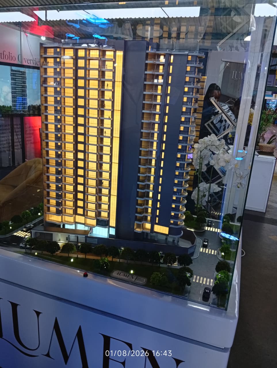A lit-up architectural scale model of the Lumen high-rise apartment development on display at the Luxury Living and Design Expo