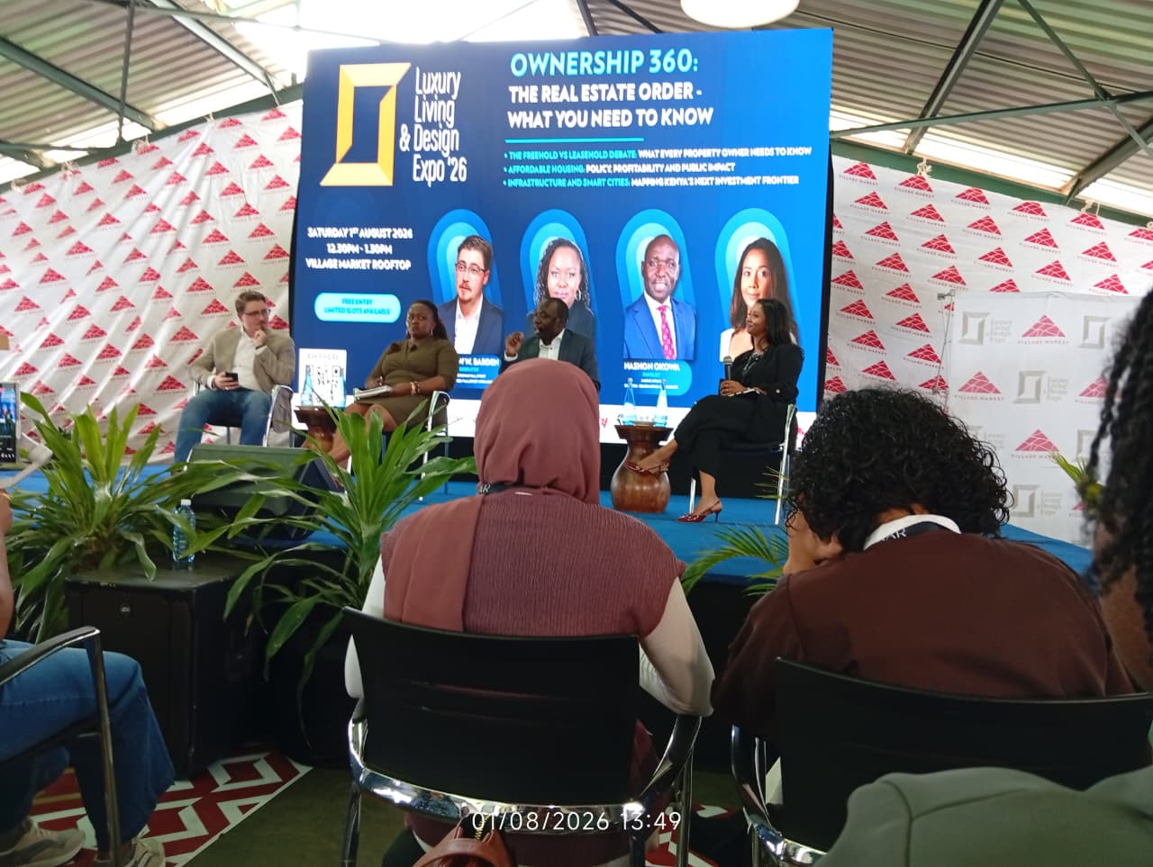 The Ownership 360 panel discussion on stage at the Luxury Living and Design Expo, Village Market, featuring the moderator and panellists seated in front of a screen displaying the panel topic