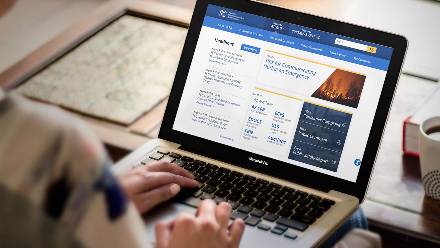 Person using a laptop to access the redesigned FCC.gov.