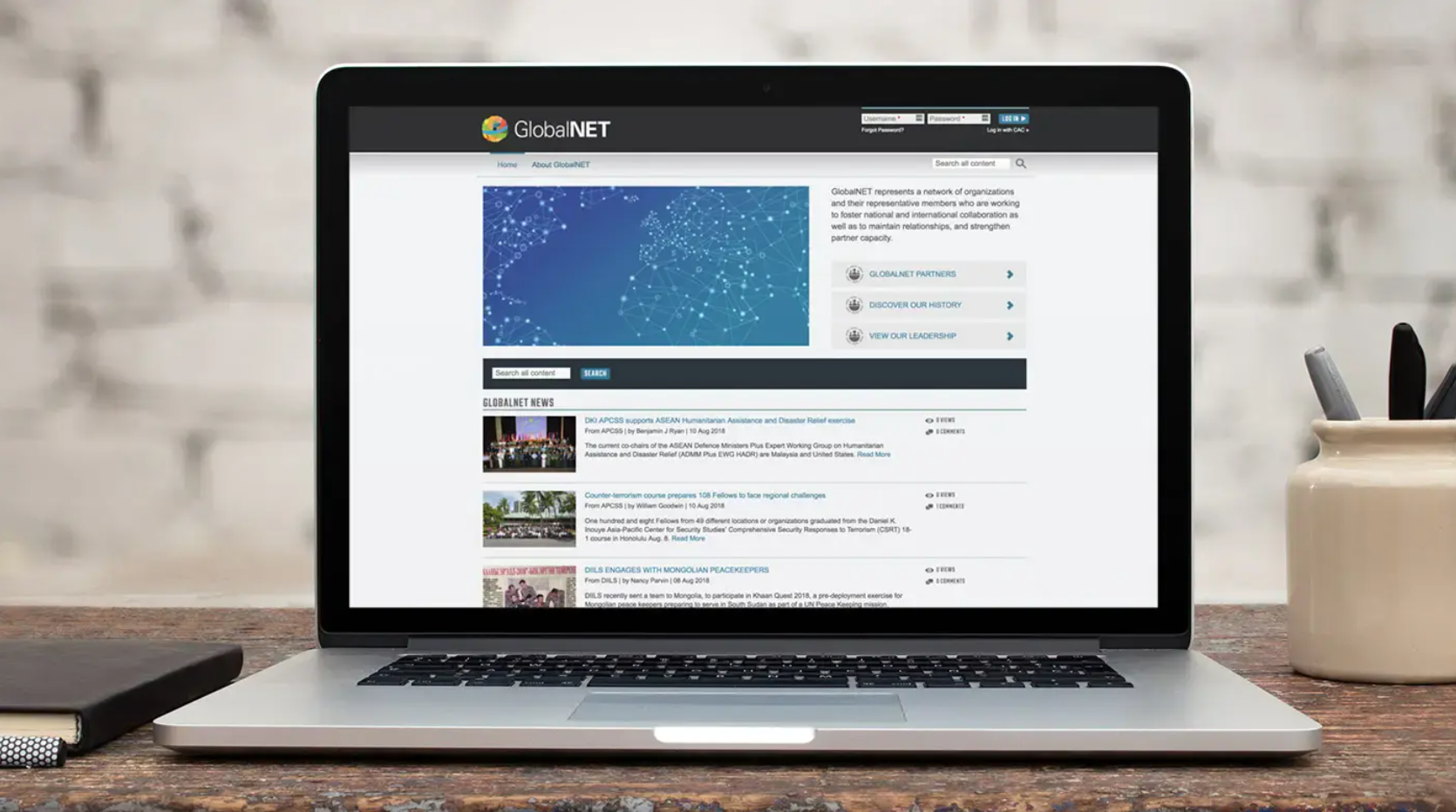 The homepage of the GlobalNET platform, displayed on a laptop