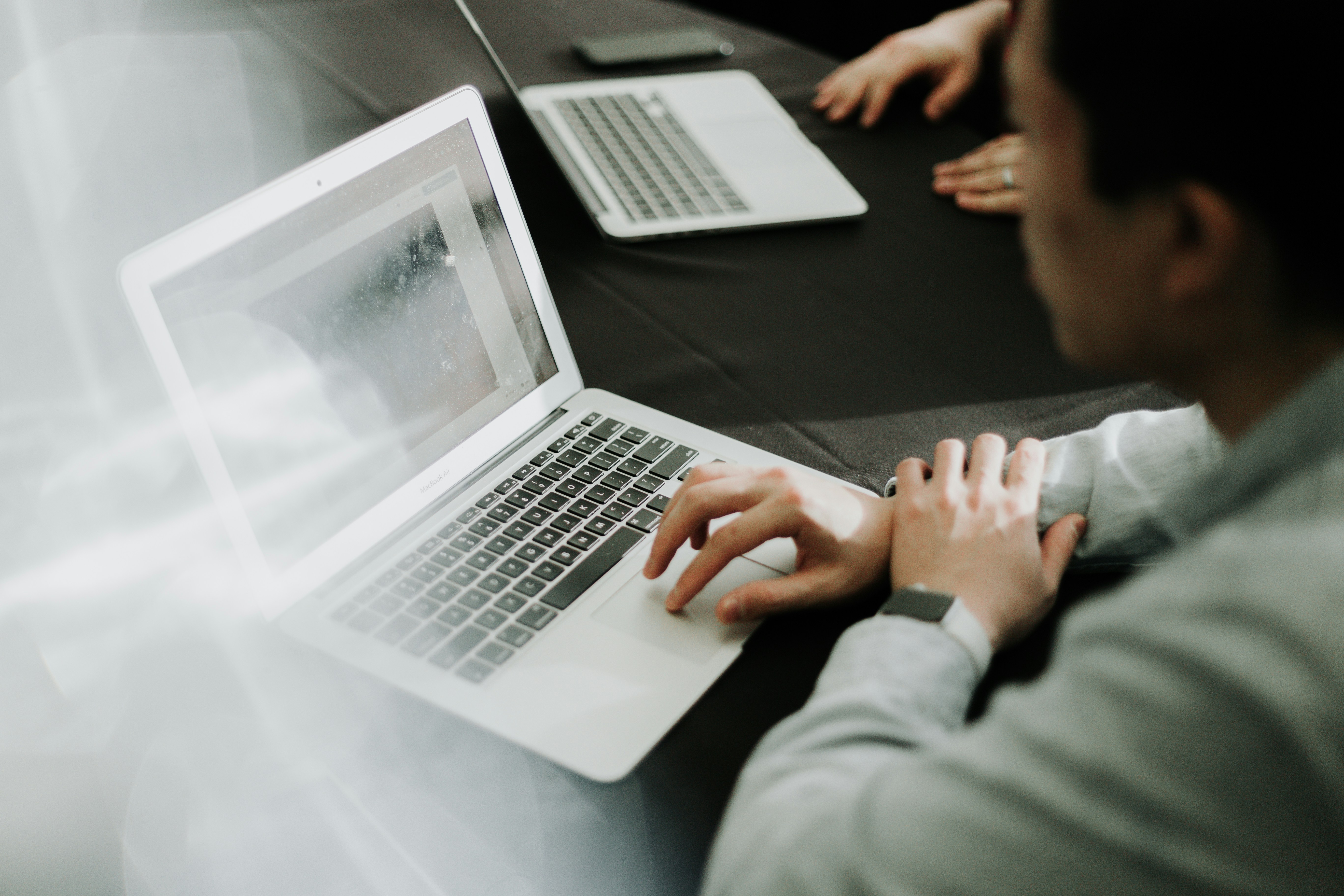 A person types on a laptop