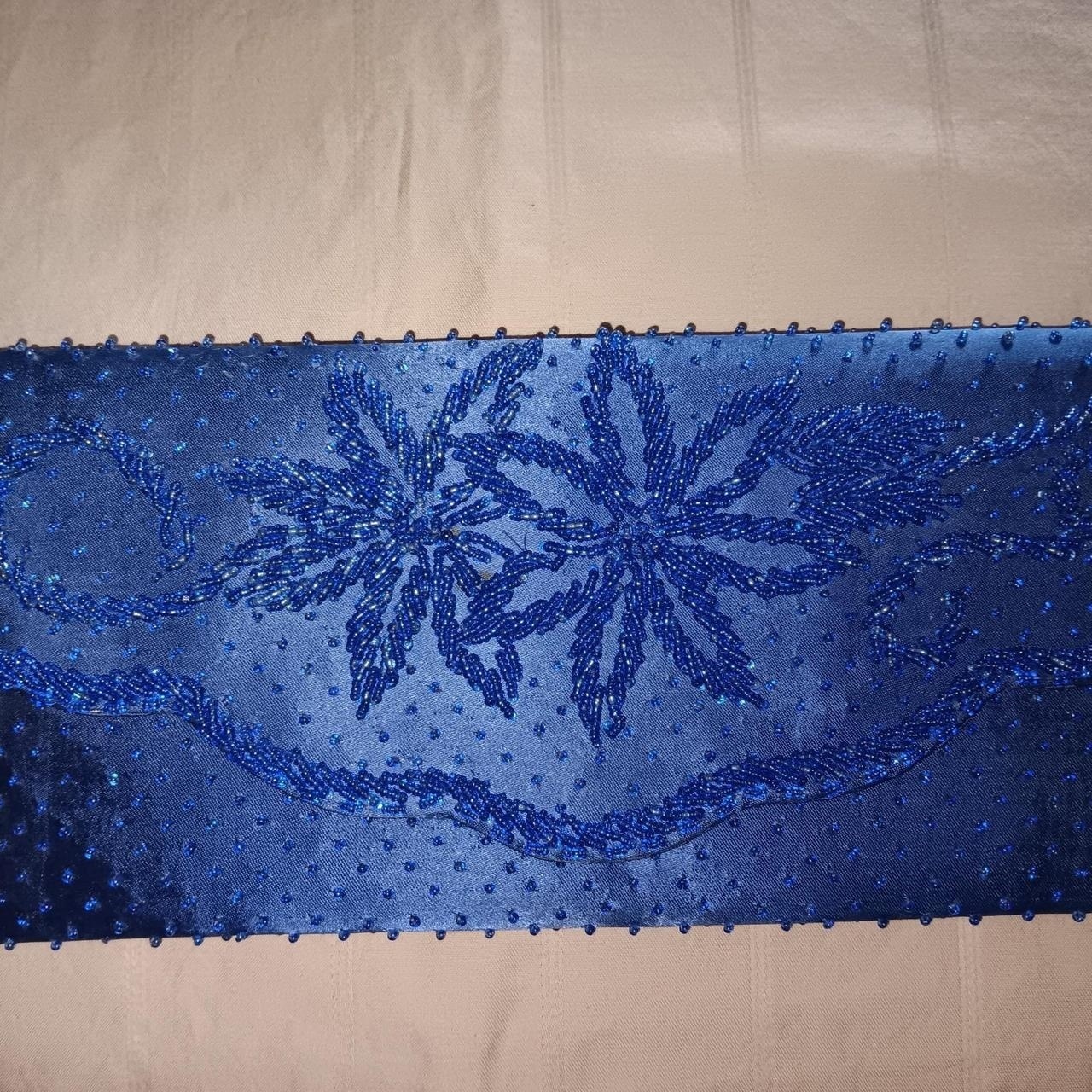 Blue beaded floral design on a sheer fabric #beaded...