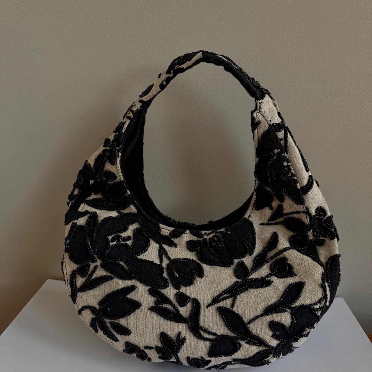 Small woven purse with black beaded flowers.