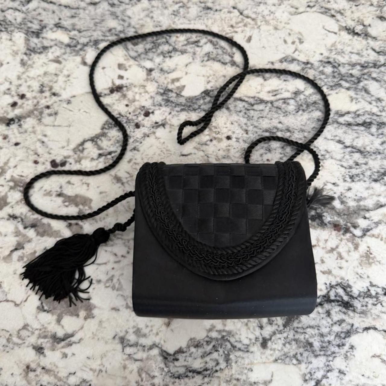 Black woven leather crossbody bag with braided trim...