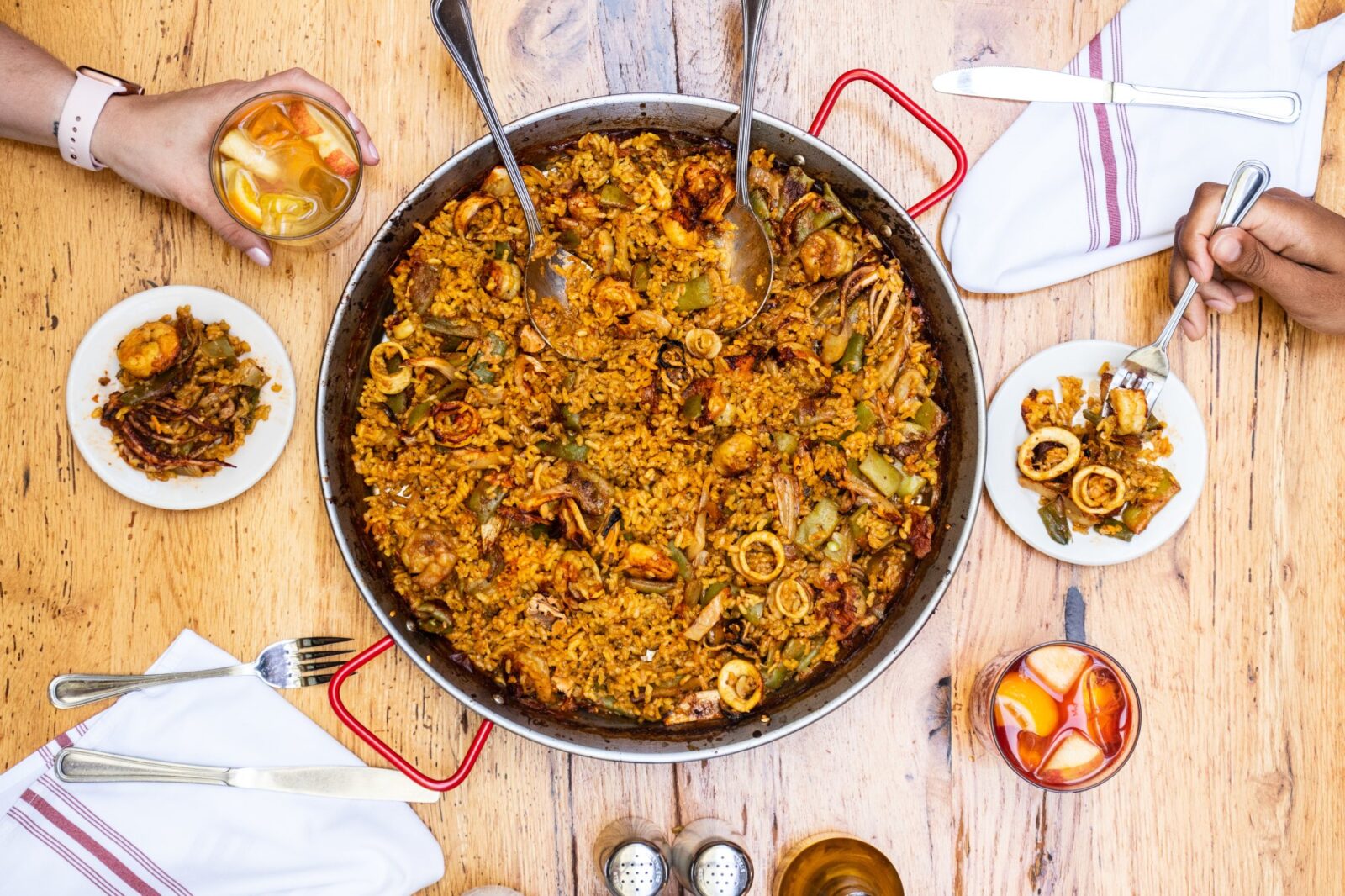 Overhead photo of Cafe Ba-Ba-Reeba! paella, sangria, tapas and place settings for the Paella Cooking Demo