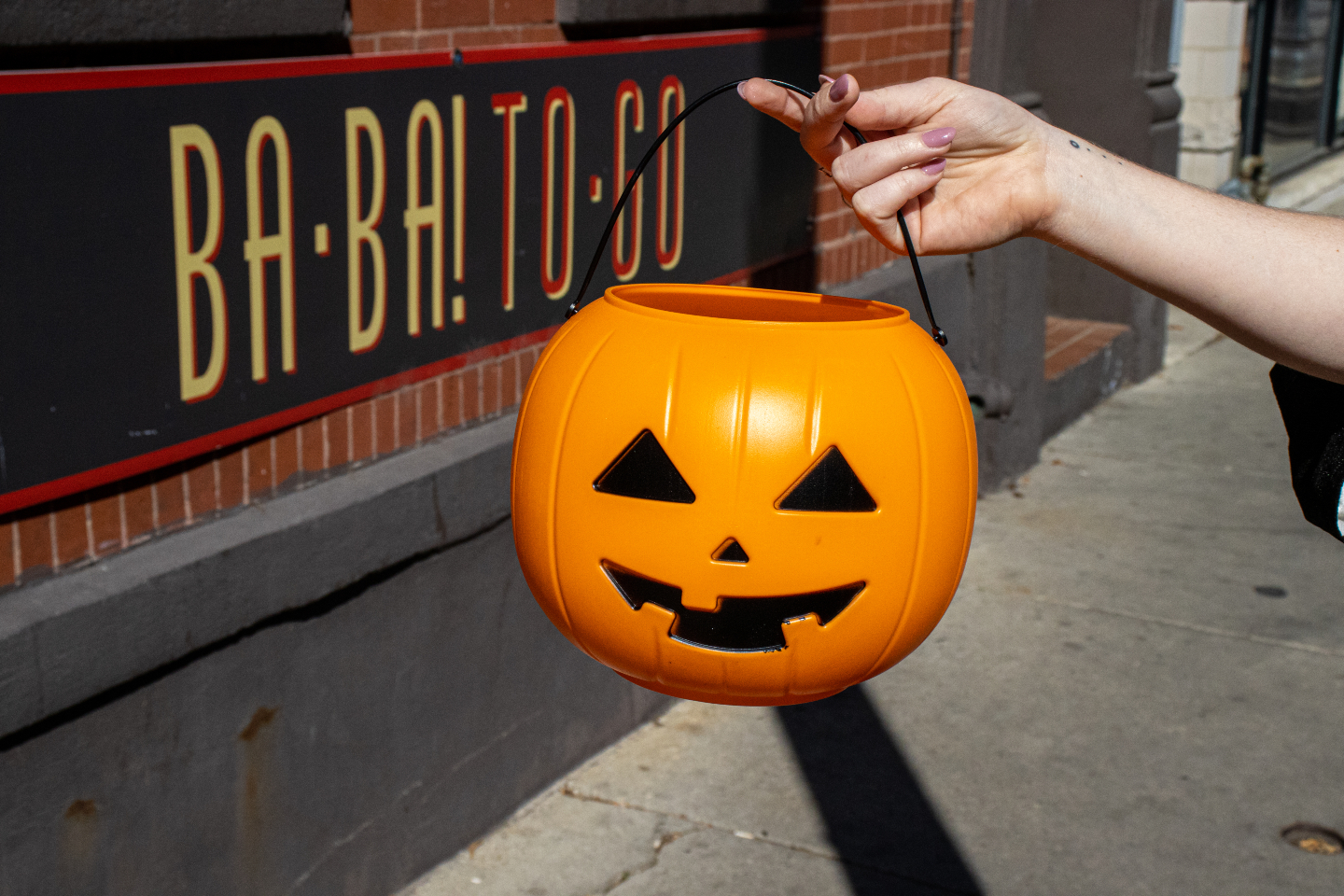 A trick-or-treat pumpkin in front of Cafe Ba-Ba-Reeba! used as a decorative image for the Halloween Specials page.