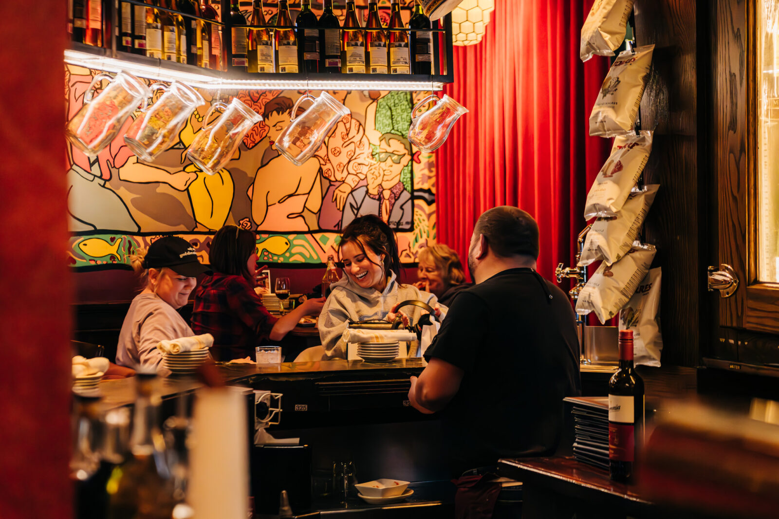 Two guests seated at the Cafe Ba-Ba-Reeba! bar laughing and smiling.