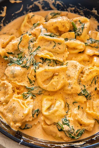 Tortelloni rápidos con espinacas en salsa cremosa de tomate
