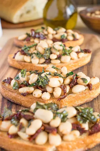 Warm Tuscan Bean Crostini with Crispy Kale