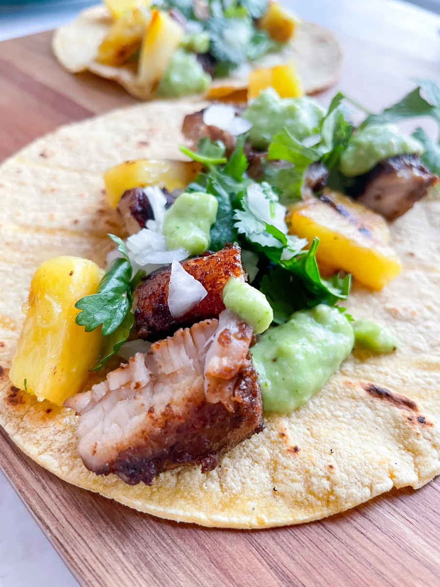 Jerk Pork Tacos with Grilled Pineapples and Tomatillo Avocado Crema