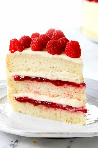 White Cake with Raspberry Filling and White Chocolate Cream Cheese Frosting