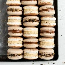 CHOCOLATE MACARONS WITH SALTED CARAMEL TAHINI MILK CHOCOLATE GANACHE AND SESAME BRITTLE